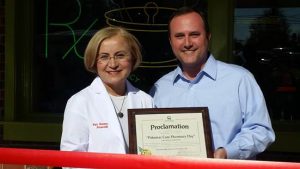 (l:r) City of Gaithersburg Councilmember Ryan Spiegel presents Pat Seremet, Owner, Potomac Care Pharmacy with a proclamation claiming November 18, 2016 “Potomac Care Pharmacy Day” in the City of Gaithersburg, Maryland at the Gaithersburg-Germantown Chamber conducted Ribbon Cutting Ceremony.   (photo credit: Laura Rowles, GGCC Director of Events & Marketing) 