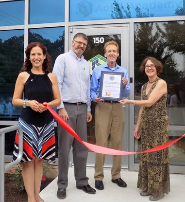 (r:l) Lynne Benzion, Director of Business Retention & Expansion, Montgomery County Economic Development Corporation presents the County Executive proclamation to Art of Problem Solving Academy’s (AoPS) Glen Dawson, National Director; Mark Smith, Campus Director and Carol Vederman, Outreach Coordinator at the Gaithersburg-Germantown Chamber conducted ribbon cutting celebration for AoPs on Friday, August 11, 2017. (photo credit: Laura Rowles, GGCC Director of Events & Marketing)