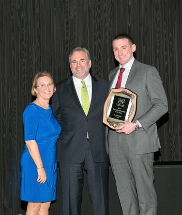 (l:r) Gaithersburg-Germantown Chamber of Commerce’s Marilyn Balcombe; President / CEO, and Total Wine & More’s Ed Cooper, Vice President of Public Affairs & Community Relations, present Brett Rough, Senior Account Executive with Aerotek the Chamber’s 5th Annual Young Professional of the Year Award at the Chamber’s Annual Celebration Dinner on December 7, 2017.  (Photo Credit: Milestones & Memories)